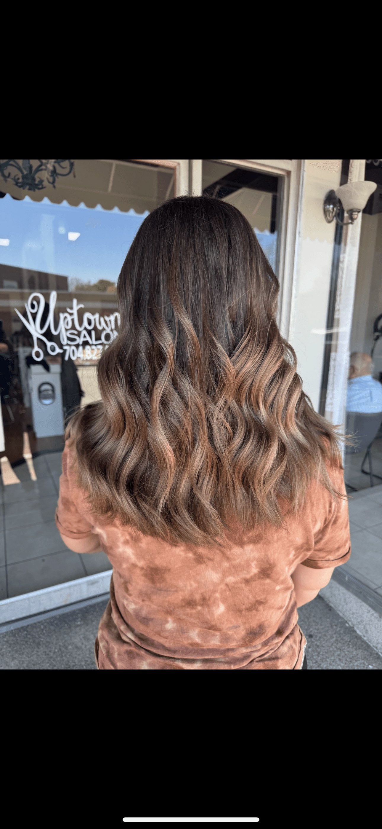 Brunette caramel balayage with long, lived-in color worn by a client of Brooke Holland.